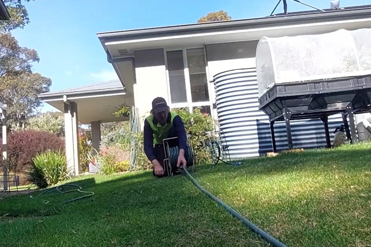 
Wrapping up his daily work, the wollongong downpipe cleaner is neatly storing his hose.